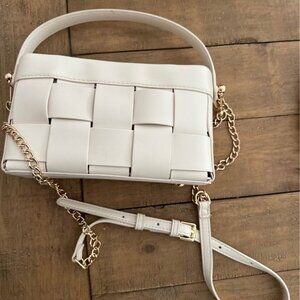 cream colored purse with gold strap